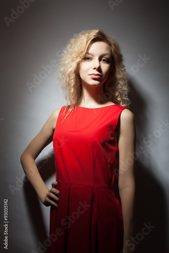Portrait of a beautiful blonde in a red dress.
