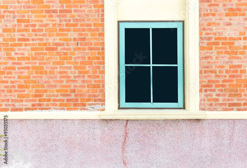 Blue window at orange brick wall of house © weedezign
