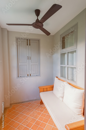 The light from the window rim the terrace house and  Cushions on upholstery fabrics in the living room of the house,vintage retro style.