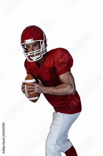 Player holding rugby ball and posing