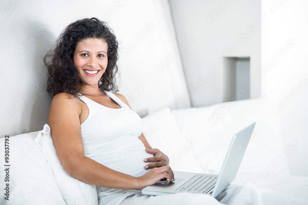 Portrait of attractive pregnant woman using laptop Portrait of attractive pregnant woman using laptop