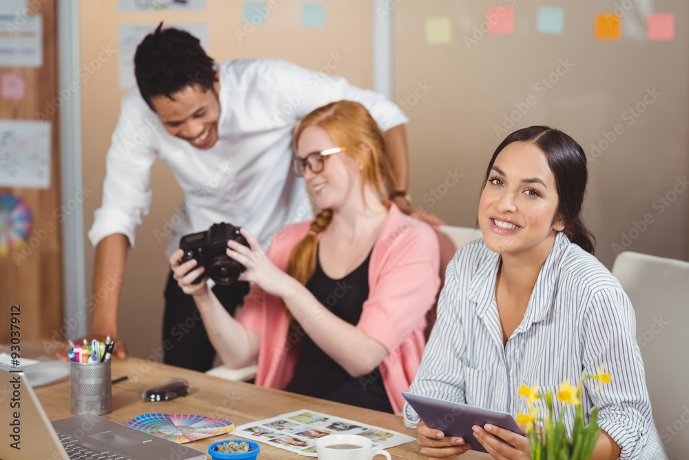 Fototapeta premium Businesswoman holding digital tablet with colleagues