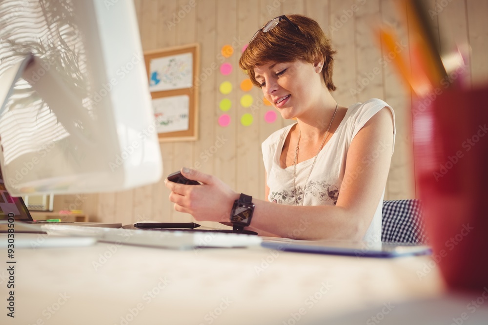 Casual businesswoman using her smartphone Casual businesswoman using her smartphone