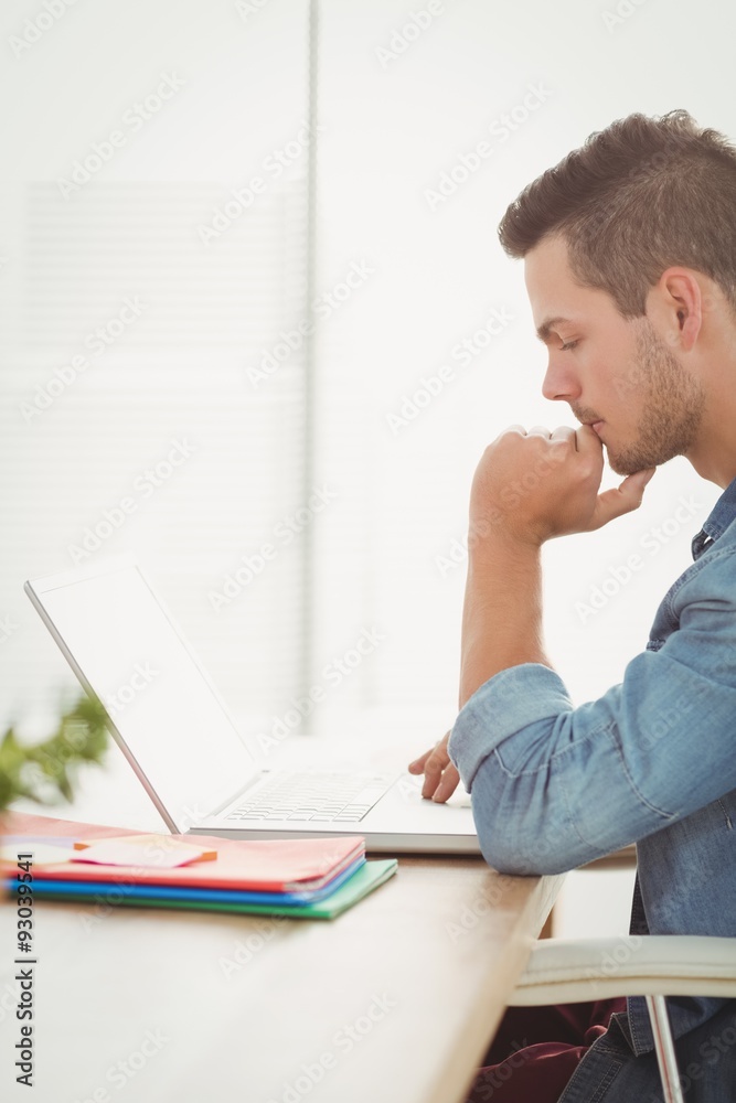 Thoughtful young man using laptop Thoughtful young man using laptop