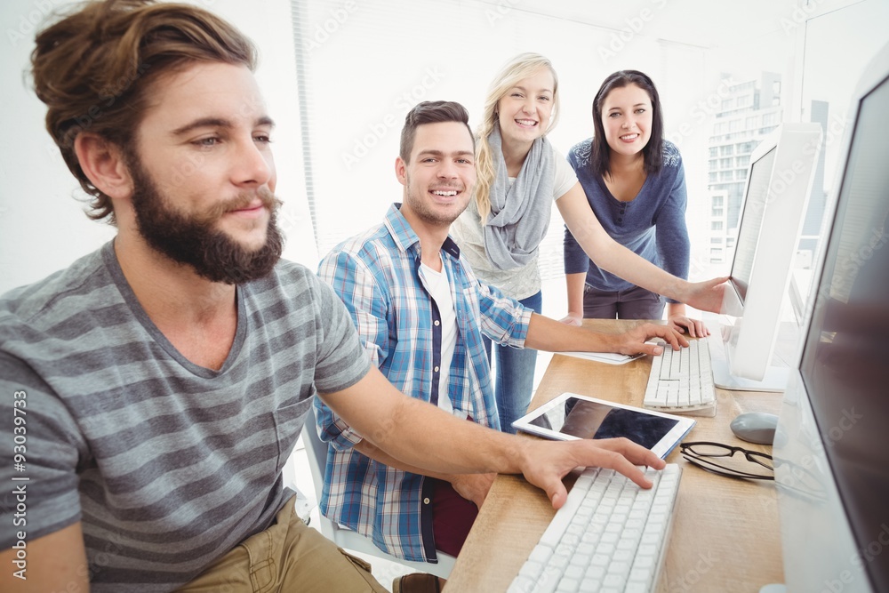 Cheerful business team at computer desk Cheerful business team at computer desk