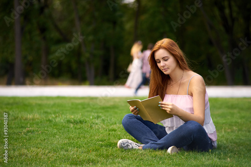 woman sitting on the lawn and reading