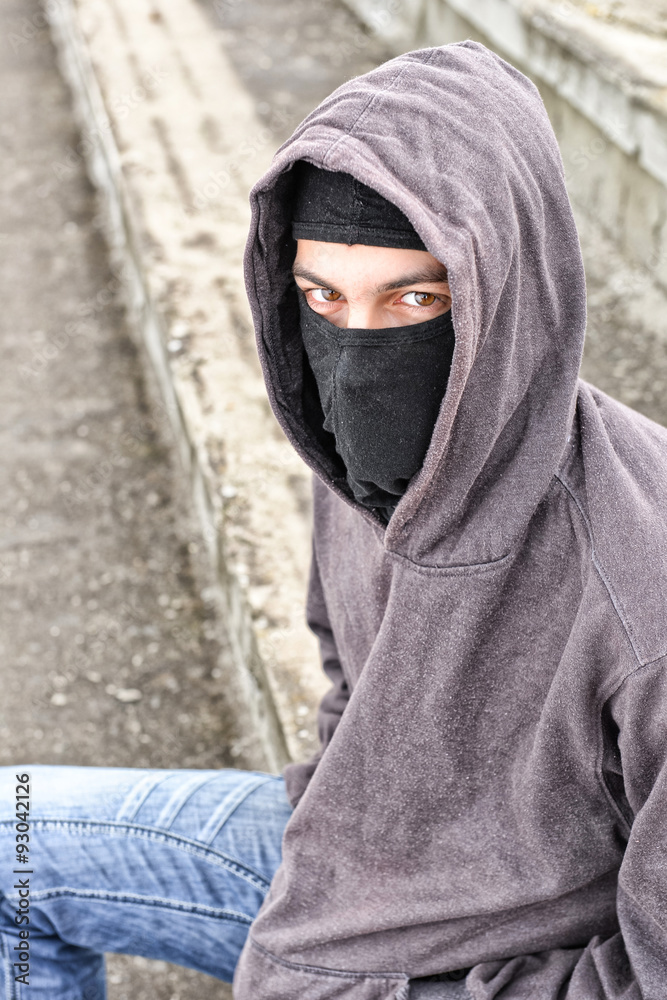 unrecognizable young man wearing black balaclava sitting on old unrecognizable young man wearing black balaclava sitting on old