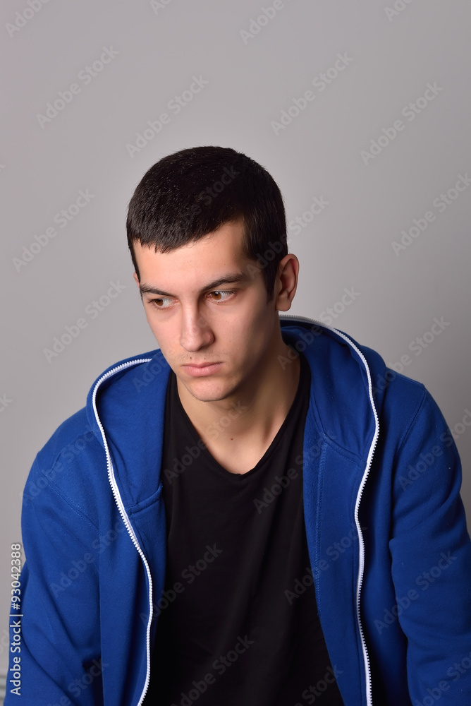 thinker attractive young man in a blue hoodie thinker attractive young man in a blue hoodie