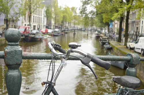 Bicycle parked on a bridge in Amsterdam