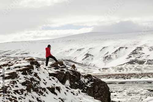 Hiker at mountain top of waterfall Godafoss