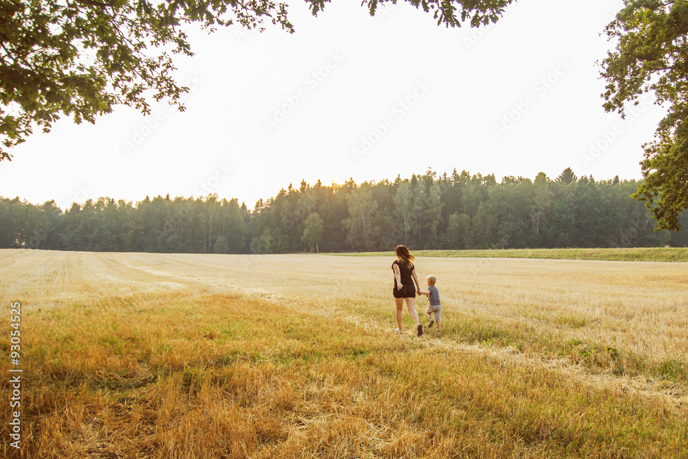 Mother with child walking across the field
Mother with child walking across the field
