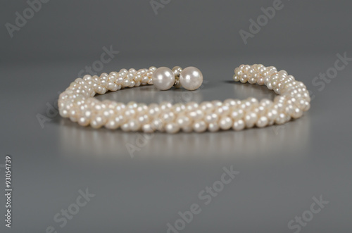 pearl necklace on gray background