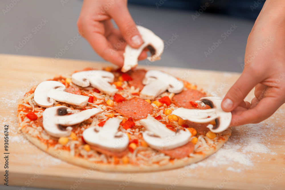 Young woman preparing pizza