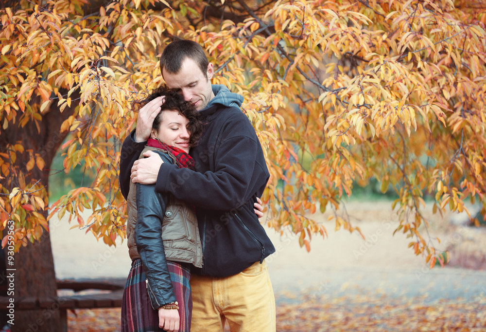 Loving couple hugging in autumnal park