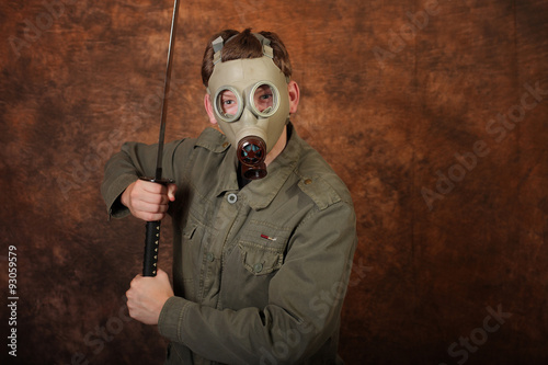 Man with gas mask and katana sword on brown batik background