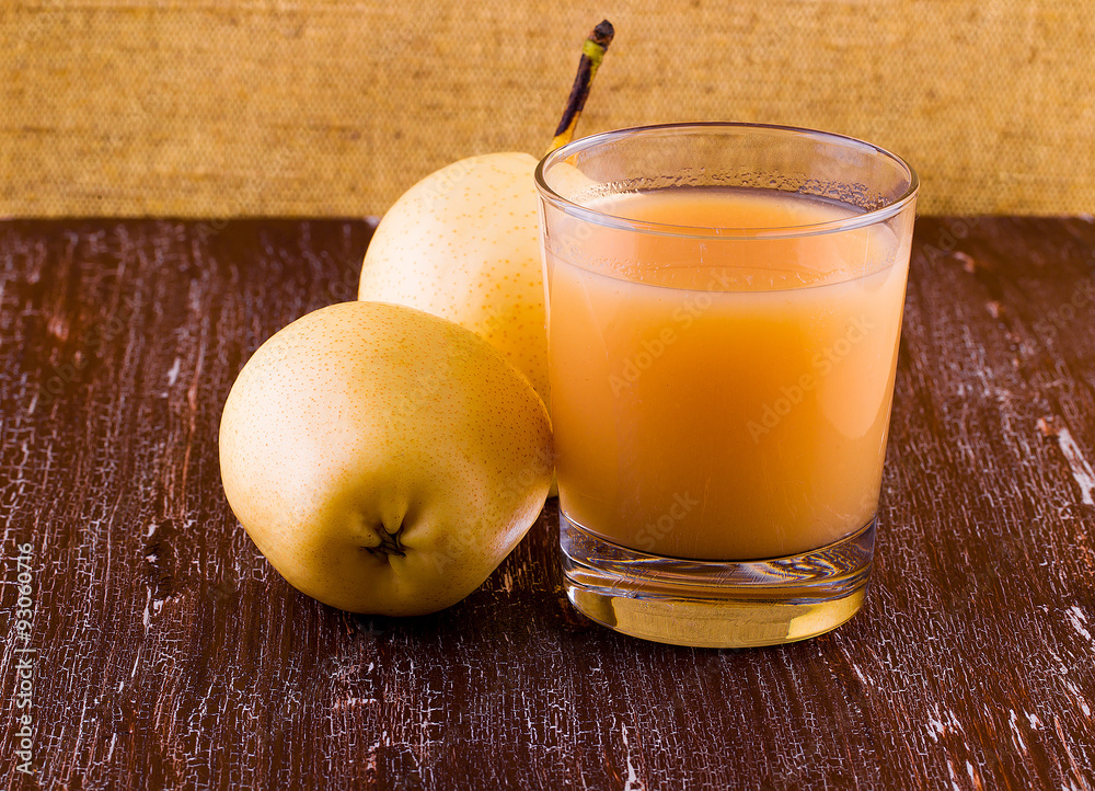 Pear and juice on a wooden table Pear and juice on a wooden table