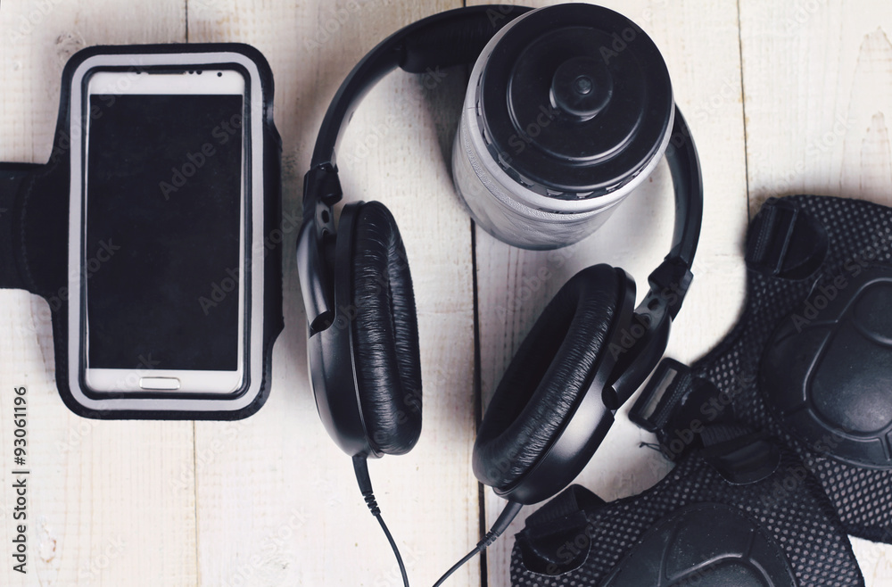 Earphones , mobile phone, Roller Skating Knee Elbow Wrist Protective Pads. Fitness, sport concept background