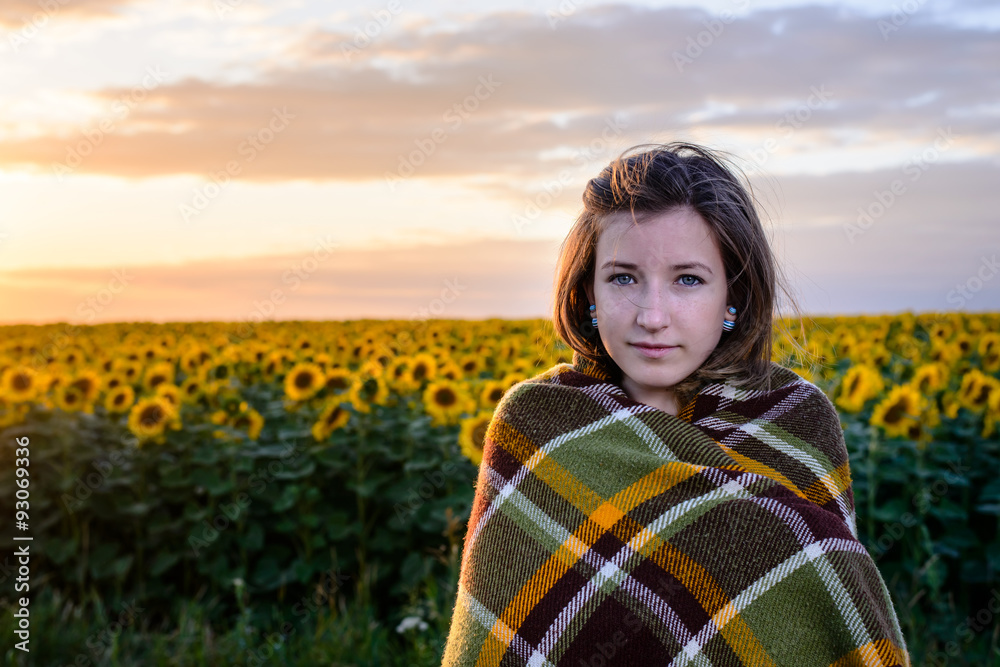 Teenage Girl Wrapped in Blanket in Sunflower Field Teenage Girl Wrapped in Blanket in Sunflower Field