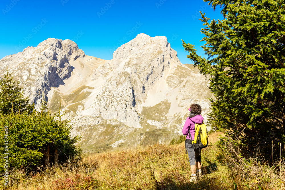 a woman hiker on a trail in the French Alps