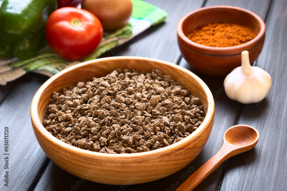 Raw textured vegetable or soy protein, called also soy meat in wooden bowl, photographed with natural light (Selective Focus, Focus one third into the soy meat) Raw textured vegetable or soy protein, called also soy meat in wooden bowl, photographed with natural light (Selective Focus, Focus one third into the soy meat)