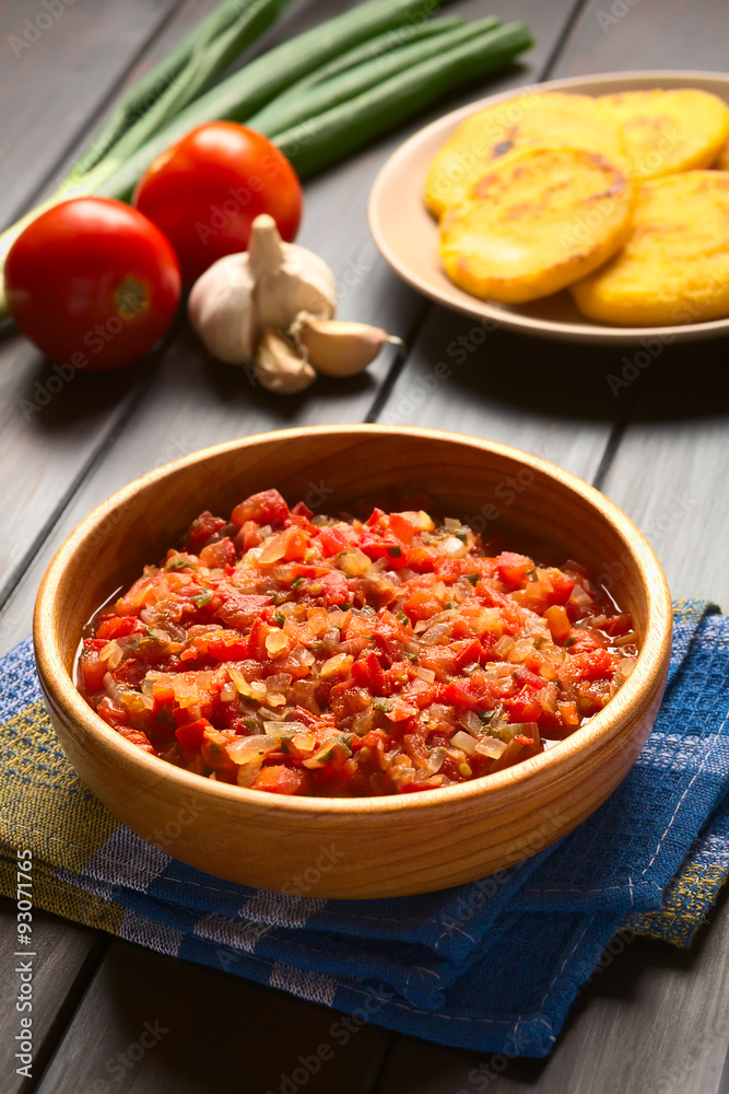 Colombian hogao or criollo sauce (salsa criolla) made of cooked onion and tomato, served as accompaniment, photographed with natural light (Selective Focus, Focus in the middle of the sauce) Colombian hogao or criollo sauce (salsa criolla) made of cooked onion and tomato, served as accompaniment, photographed with natural light (Selective Focus, Focus in the middle of the sauce)