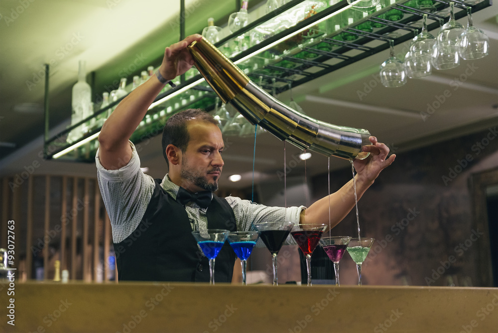 Fototapeta premium Barman is making cocktail at night club