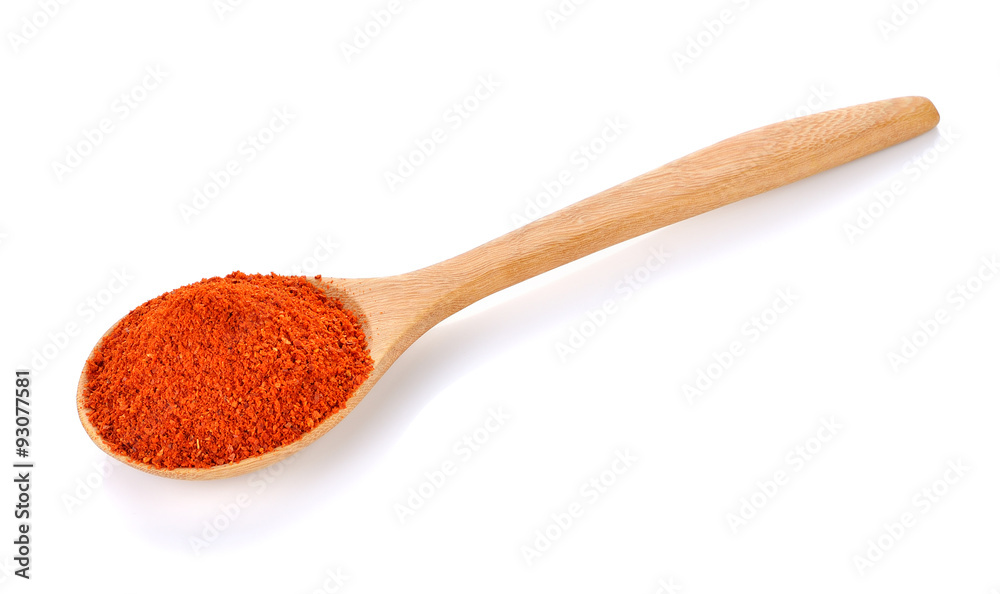 paprika powder on wooden spoon isolated on white paprika powder on wooden spoon isolated on white