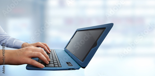 Hands typing on computer laptop.