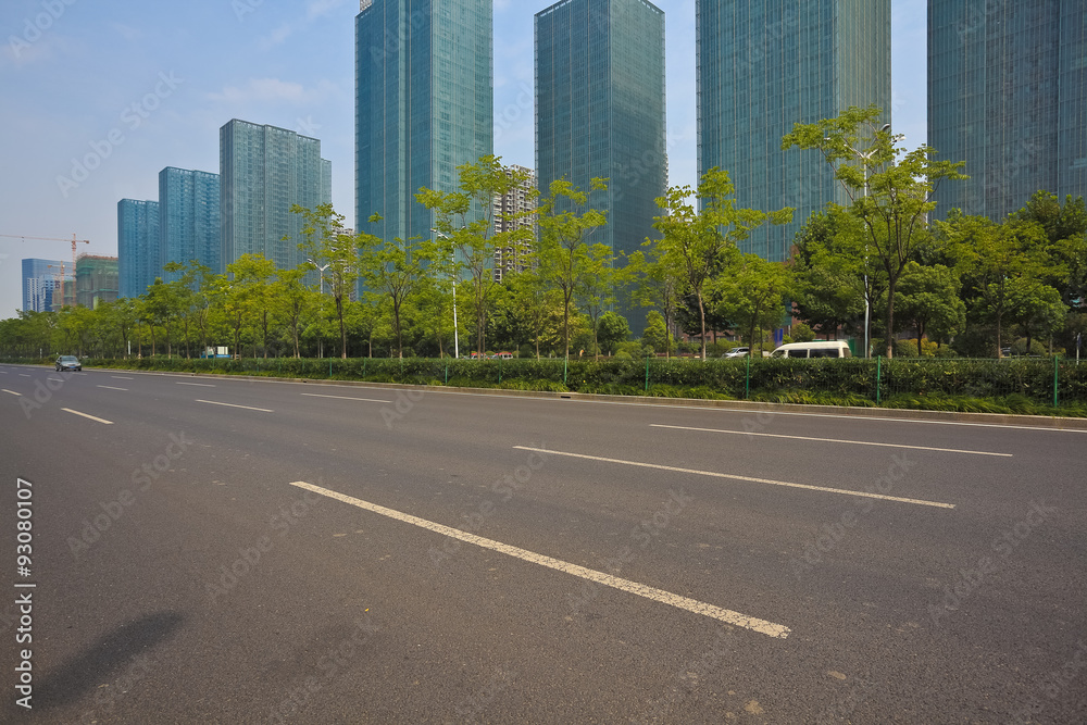 Empty road surface with modern city buildings background