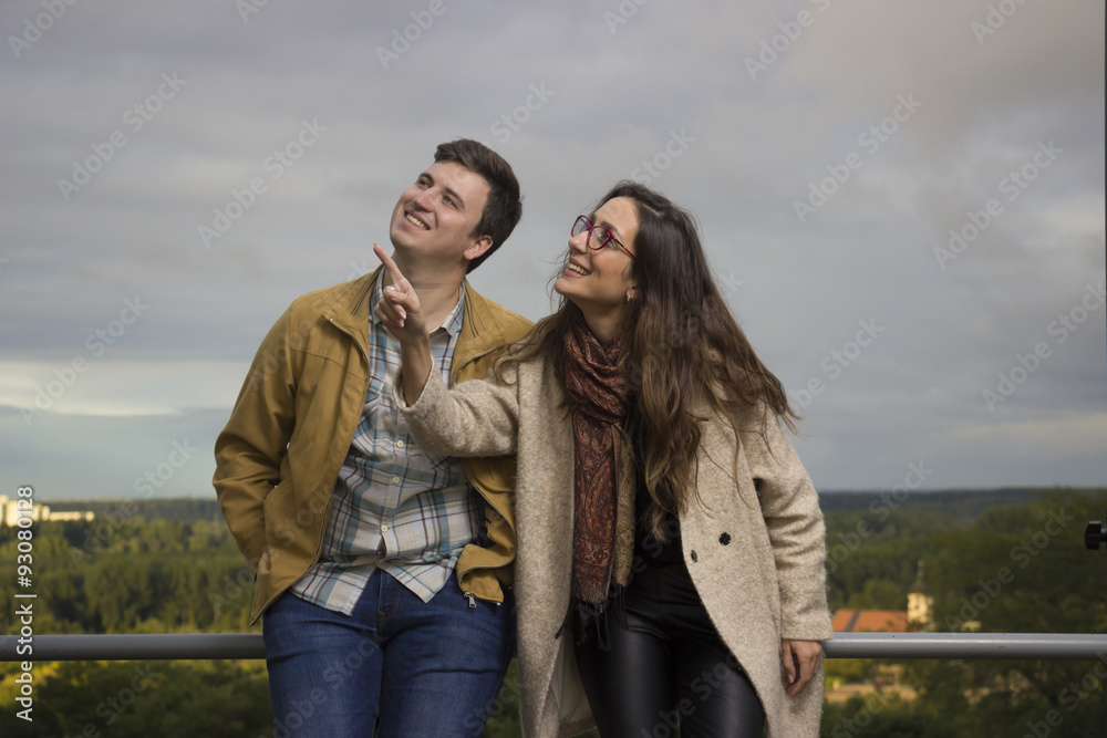 Young happy couple poiting to sky up. Young happy couple poiting to sky up.