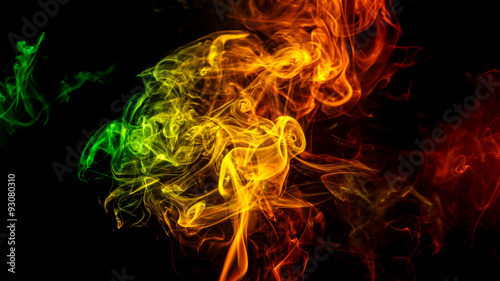Abstract yellow - green - orange smoke from aromatic sticks.