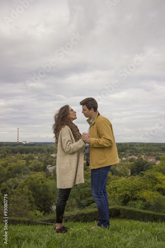 Young intimate couple standing on high viewpoint. Romantic lands © HD92