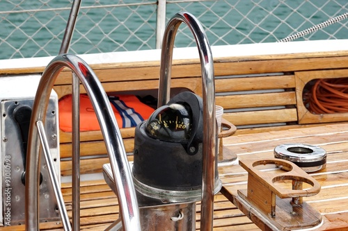 Metal Large Steering Wheel And Compass On The Sailboat photo