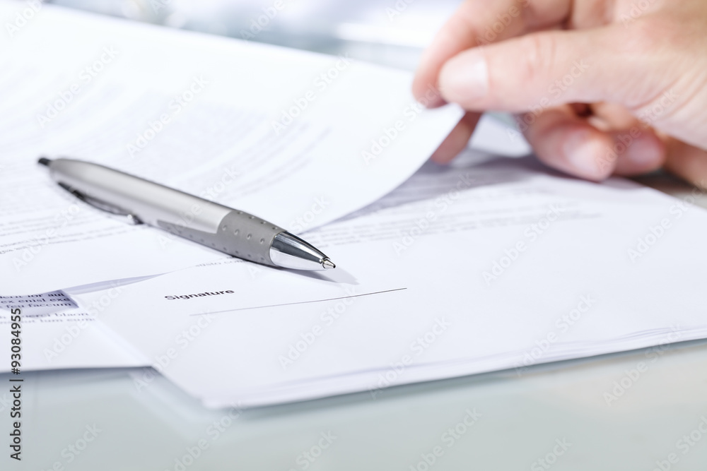 Close-up of a silver pen with documents. Close-up of a silver pen with documents.