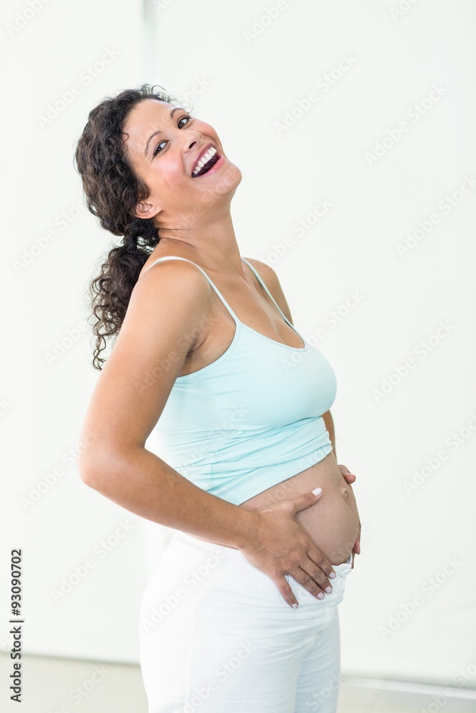 Happy pregnant woman touching her belly Happy pregnant woman touching her belly