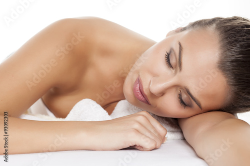 portrait of a beautiful young woman lying on a white background