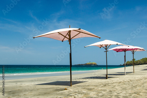 pink umbrella on a tropical beach with a beautiful ocean view