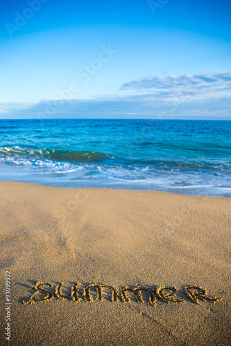 beach background with word summer written in sand