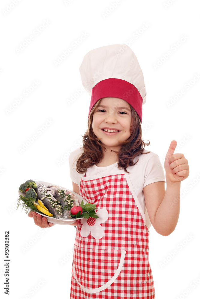 happy little girl cook with trout fish and thumb up happy little girl cook with trout fish and thumb up