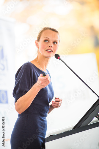 Pretty, young business woman giving a presentation Free Download Pretty, young business woman giving a presentation - GFXLoad