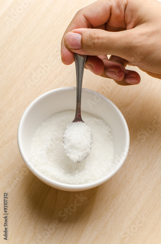 The spoon of sugar in the bowl