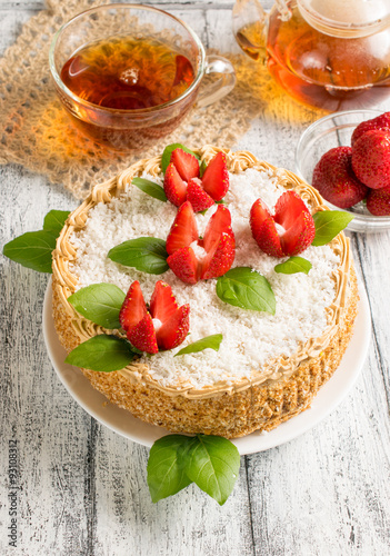Celebratory cake with strawberry flowers and tea