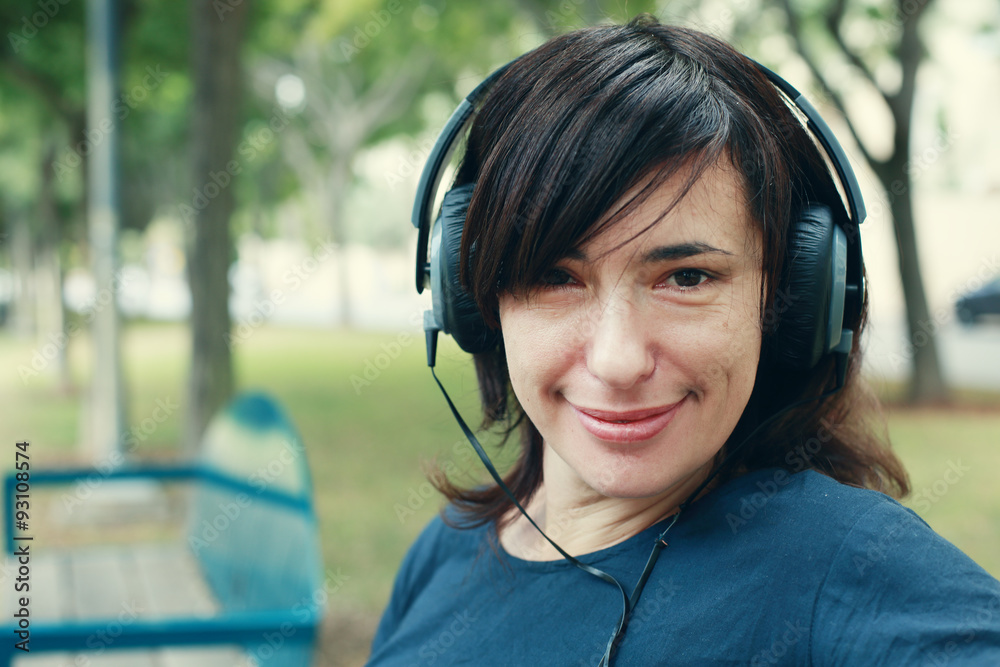 Beautiful Woman with Headphones Outdoors Beautiful Woman with Headphones Outdoors