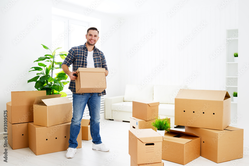moving to a new apartment. happy man with cardboard boxes moving to a new apartment. happy man with cardboard boxes