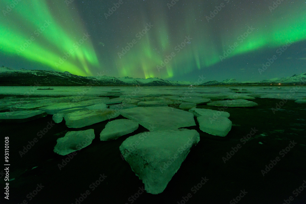 A beautiful green and red aurora  over the Jokulsarlon lake, Ice