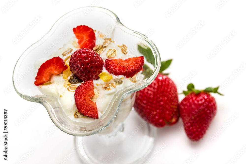 Glass of Muesli with strawberries and yogurt isolated on white Glass of Muesli with strawberries and yogurt isolated on white