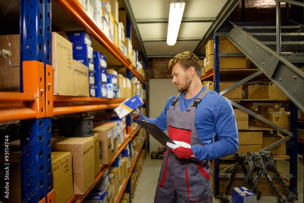 Worker on a automotive spare parts warehouse