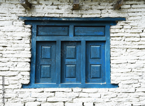 closed up the blue wood door with brick wall, in village Nepal