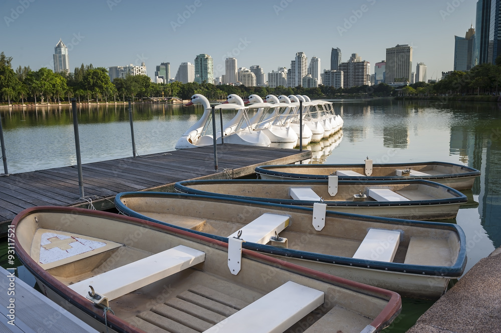 The line of Boats and Swan Pedal in the pond of the Benjakiti Park, Bangkok.