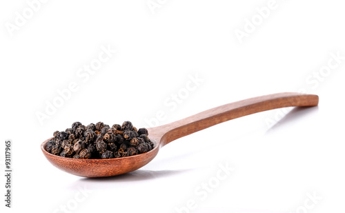 Black pepper seeds on white background.